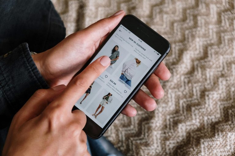 Person Holding Black Iphone and shopping online