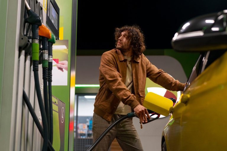 Man filling up his car at petrol station